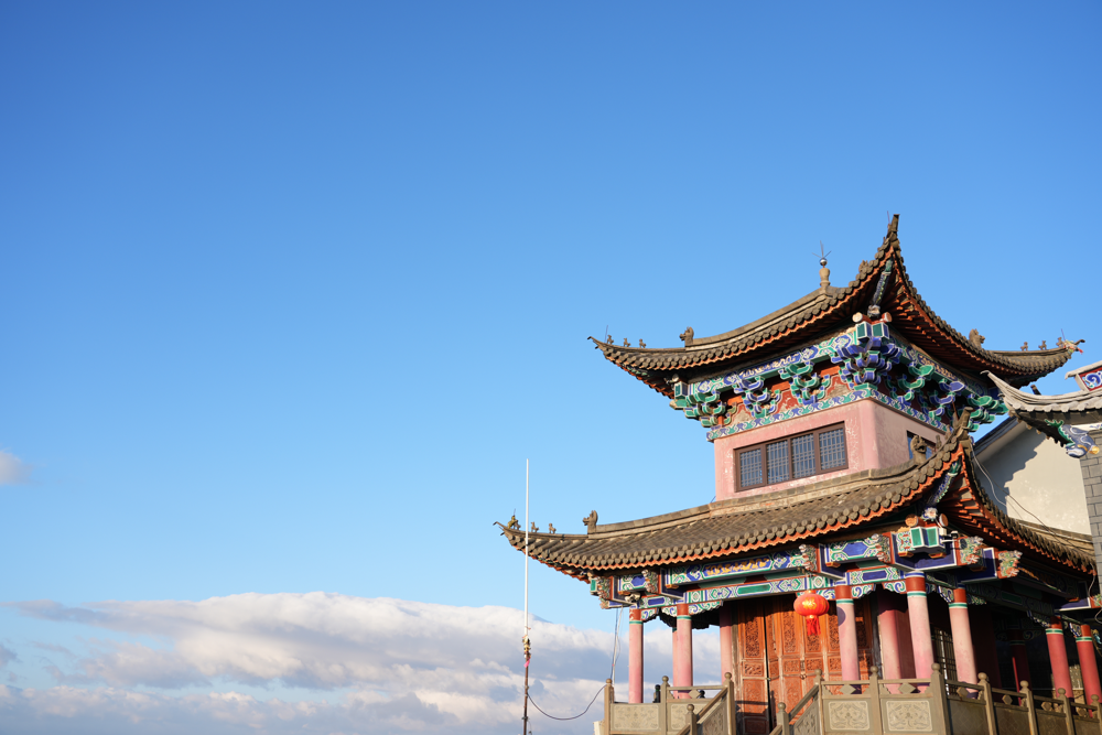 Temple roofs and an open mountain horizon
